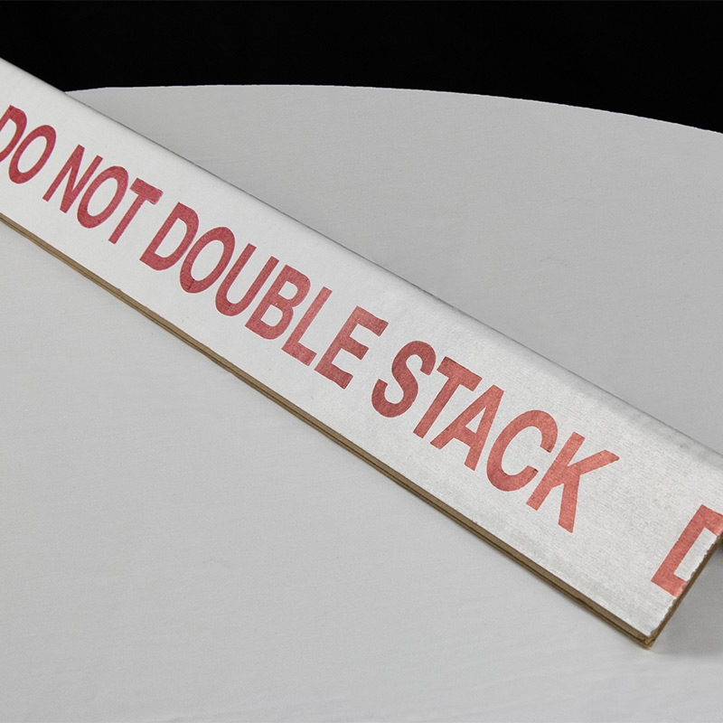 cardboard corner protector with instructions printed stating do not double stack